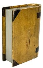 **SOLD** M324 Unique carved wooden book shaped box with hinged Cover/Lid retaining its original mustard and brown painted surface. This �book� is made to appear all the more realistic with its rounded binding with added paint accents to look like title bands and recessed / painted �pages�. Natural patina interior of the box Is lined with a newspaper article from �The Locomotive Engineer�s Journal for October, 1927�.  Measurements: 7� wide x 2 &frac34;� thick x 9 &frac12;� tall. 