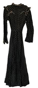 (i315) Late 19th century Woman�s black and white dress with lined bodice and pressed leather buttons. This dress features decorative ruffles and woven cotton trim typical of the period. Very nice condition. Circa 1880s-1910.  