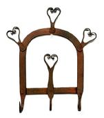**SOLD** M203 Early hand-forged Iron hanging rack featuring handmade hearts and three hooks � retaining remnants of early red painted surface. Measurements: 8 3/8� wide x ~1 &frac34;� deep (at hooks) x 9 &frac12;� tall. 