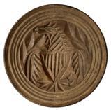 K1649 19th century tall, handled chip-carved butter print stamp of Pennsylvania origin depicting an Eagle with shield and arrows. Incised rings encircle the outer edges. Carved from a single piece of wood. Natural patina surface. Measurements: 3 5/8� diameter x 2 &frac12;� tall 