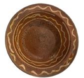 **SOLD** M295 19th century Pennsylvania Slip-Decorated Redware Bowl with lipped edge bearing beautiful deep reddish orange color with yellow slip decoration. Wear commensurate with age. Measurements: 8� top diameter x 4 &frac34;� bottom diameter x 2 &frac14;� deep.  