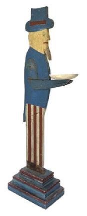 **SOLD** M161 Folk Art wooden Uncle Sam figure holding a small round hand carved bowl. Maker�s stamp on bottom reads �Frank Smith Finney�.  Original red, white and blue painted surface. Measurements: ~14� deep x ~37 &frac12;� tall. The bowl is 5 1/8� diameter. Base measures 6 5/8� wide x 10 5/8� deep. (NOTE: Royland �Frank� Smith Finney (b. 1947) from Cape Charles, Virginia is a well-known and highly sought after Southern Folk Artist.)   