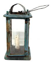 **SOLD** M251 19th century original blue painted wooden Lantern featuring four bubbled glass panels contained within a wooden pinned and post construction frame.  The wood is pine. The door to access the interior candle socket is attached with tiny wire loop hinges and secured with a tiny wire loop that turns to open the door. There is a hole in the top for ventilation purposes which is covered on the exterior with a curved piece of sheet metal to create a hood that protects the candle flame from wind/rain. A wire bale handle is attached to the top for carrying/hanging purposes. Circa mid-1800s. Measurements: 5� square x ~9 &frac34;� tall � not including handle.  
