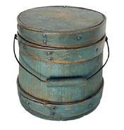 **SOLD** L500 Small 19th century New England firkin bearing original blue painted surface. Thick walled staved and bentwood construction with wire bail swing handle with wooden handle grip. Overlapping finger on all three wooden bands are secured with small copper tacks and a tiny copper wire staple at the tips. Natural patina interior. Measurements: 6 &frac34;� diameter (Bottom) x 6 &frac14;� diameter (top) x 6 &frac12;� tall.