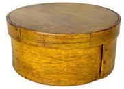 **SOLD** L225 New England round pantry box in old mustard painted surface over the original red paint. Steamed and bentwood construction secured with tacks and tiny wooden pins. Clean, natural patina on the inside. Measurements: 7 &frac12;� diameter x 3 3/8" tall. 