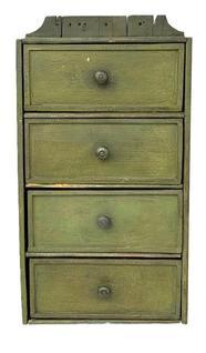 L195 19th century Pennsylvania hanging set of four drawers bearing its green painted surface. Drawers have molded edges. Small wire nail construction with original knobs. The wood is pine. Circa 1870s. Measurements: 12� wide x 5 &frac34;� deep x 23 &frac34;� tall (back). 