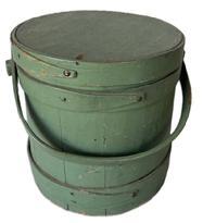 M618  19th century, medium sized firkin or sugar bucket in original dry green paint. It has a wooden swing handle attached by large buttonhead wooden pins. Old nails or tacks hold the lap bands in place. In great condition with nice patina. measurements are (' across the top x 9 1/2" tall x 9 1/2" diameter bottom