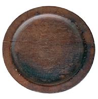 L510 Wooden plate with wide lipped edge resting on a slightly raised foot. Dark, natural patina with tight age cracks and surface wear. Out of round. Measurements: 7 1/8� x 7 &frac12;� diameter x ~ &frac34;�tall. The lipped edge is &frac34;� wide and ~1/8� thick. 