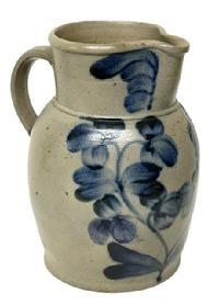 M163 Beautiful 19th century Baltimore, Maryland Peter Herman one gallon Crock Pitcher � stamped �I� just below the spout. This stunning stoneware pitcher was made in Baltimore circa 1850 � 1870s. It is decorated in cobalt with a two-stemmed flowering plant, along with flowers on the rim and highlights at the handle terminals. Approximate measurements:  6� diameter (bottom) x 10� tall. 