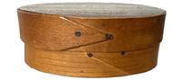 L468A 19th century Shaker miniature opposing finger lap oval pantry box with �H. V. Baker� stenciled in black on the bottom, and inside the lid. Natural patina surface throughout. Partially indistinguishable handwriting in pencil on the top of lid indicates this box held seeds in 1918. Exceptionally fine, delicate steamed and bentwood construction with top and bottom being secured with tiny wooden pegs and overlapping fingers secured with tiny tacks. Diminutive oval measurements: 4 3/8� wide x 3� deep x 1 5/8� tall. 