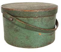 **SOLD** L112 19th century Bail Handle Pantry Box in original green painted surface. This Pantry Box is sturdy, thick walled with its original wooden bail handle bearing an early break repair to one side of handle. Overlapping bentwood sides secured with small metal tacks. The lid has overlapping finger joint secured with small tacks. Nice wear with natural patina interior. Measurements:  11 &frac34;� top diameter x 11 &frac14;� bottom diameter x 7� tall (not including handle).