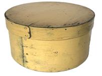K1874 19th century New England pantry box in wonderful pale-yellow paint over the original blue-gray surface. The steamed and bentwood constructed overlapping sides and rim of lid are secured with small tacks. Great natural patina inside. Measurements: 8 &frac12;� diameter (bottom) x 8 &frac34;� diameter (top) x 4 &frac14;� tall.