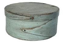 K1873 19th century New England pantry box in original dry, gray paint with opposing single finger laps on both body and lid. Steamed and bentwood sides and rim are secured to top and bottom of box with tiny wooden pegs and miniature tacks. Dark patina on interior consistent with age and use. Measurements: 7 7/8" diameter (top) x 3 &frac14;� tall. 