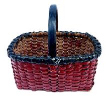 M275 EXCELLENT early 20th century small sized hand-woven splint gathering basket � possibly of North Carolina origin � bearing the original black and red painted surface. The rectangular form boasts tight weave with a double wrapped, double rim with handle that is woven into the sides and secured with a small tack on each side. Appears to be made of white oak and river cane construction, which is typical of NC baskets. No breaks or losses and very minor flaking to the paint. Measurements: 9 &frac14;� x 6 &frac34;� x 5� tall sides. ~8 &frac14;� tall including handle. 