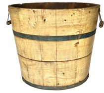 K1724 19th century Pennsylvania wooden bucket retaining original mustard grain painted surface with original blue painted metal bands securing the staved sides. Original bale handles remain intact on each side of the bucket. Measurements: 16 &frac14;� top diameter x 13� bottom diameter x 13 &frac12;� tall.  