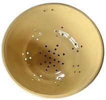 L47 Scarce 19th century Yelloware / Yellow ware Stoneware Colander. There is a set of �hanging holes� up by the rolled rim, and a series of diamond-shaped holes that surround the footed base. The pattern of holes within the footed base create a snowflake style pattern. Excellent condition. Measurements: 9 &frac14;� x 9 &frac34;� diameter x 4� tall.  