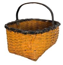 **SOLD** M48 Early woven splint Gathering Basket with sturdy steamed and bent, notched handle with original black paint on the rim and handle, and original pumpkin paint on the rest of the basket. Basket construction boasts a tightly woven decorative double rim with oval opening tapering to a rectangular bottom. The double rim is double wrapped on the sides, and single wrapped on one end, with losses to the wrap on opposite end. Measurements:  14 &frac12;� x 11 &frac12;� top opening. Bottom is 11 &frac12;� x 7 &frac12;�.  The sides are 6 &frac12;� tall. Overall height is 11 &frac12;� tall including handle. 