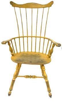 E494A Bench made Philadelphia seven spindle comb back Windsor Armchair bearing beautiful yellow painted surface. Measurements: Seat is 21� wide x 15 &frac34;� deep x 17 &frac12;� tall. Overall height in back is 44 &frac34;� tall. 27� across arms.  