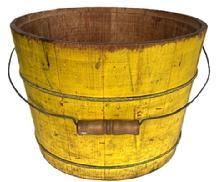 **SOLD** K1856 Late 19th century original vibrant chrome yellow painted bucket from Pennsylvania with arched wire bail handle and turned wooden grip. The interior is old natural patina. Tongue and grooved staved construction held in place with thick wire bands. A child�s penciled drawings adorn one side   Measurements:  13 &frac14;� top diameter x 11 &frac14;� bottom diameter x 9 &frac12;� tall.  
