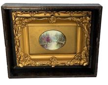 M83 Stunning miniature landscape painting depicting a tranquil stream in a wooded area with soft foliage colors with extremely impressive reflection details. Appears to be hand painted oil on porcelain in a very ornate miniature gold gild frame that is encased in a black painted wooden shadowbox frame. Circa 1880s. Shadowbox measures 9 5/8� wide x 7 &frac34;� tall x 2� deep. Oval painting area measures 3� wide x 2 &frac14;� tall. 