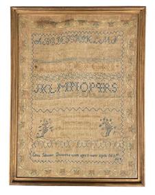K37 Early 19th century hand wrought Sampler with two sets of alphabets in varying stitch styles with a very intricate floral and vine outer border and detailed inner border and row dividers. The blues, greens, ecru and tans are hand stitched onto a linen background. The maker stitched: �Eliza Johnson Dennys'es work aged 8 years Aprile the 25th 1824" along the bottom rows, along with a central verse with flowers on each side. The verse reads: "Teach me to feel another's woe, To hide the fault I see, That mercy I to others show, That mercy show to me". (This is a verse by English Poet, Alexander Pope.) The sampler is encased within an early wooden frame with remnants of gold paint. Overall Frame size measures: 14" wide x 18 &frac12;� tall. Sampler opening measures: 12 &frac12;� wide x 17" tall. 