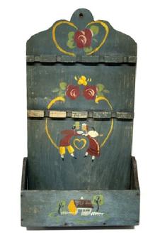 RM1645 Late 19th Century hanging Spoon Rack/ wall Box. One single back board with a cut out design at the top in original blue painted surface with hand painted decorations of Pennsylvania Dutch influence. There are two levels of spoon holders for holding up to a total of nine (9) spoons, over a candle box with shaped sides. The wood is pine with small wire nail construction. Measurements: 9 5/8� wide (back) x 18 &frac12;� tall. The bottom wall box area is 10 &frac14;� wide x 4 &frac14;� deep. 