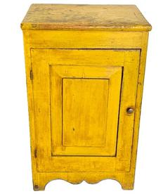 **SOLD** M125 Wonderful mid-19th century Pennsylvania one door cupboard in original yellow painted surface with a beautiful, raised panel door that is fully mortised and pegged, resting on nice cut out apron and feet. Two board back and clean, natural patina interior with sturdy shelf for storage. The wood is pine with square head nail construction. Circa 1850s-1860s. Measurements� 18 &frac14;� wide x 15� deep x 29 &frac12;� tall. 