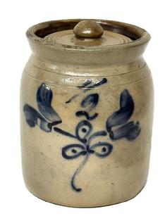 M162 Small Cobalt Decorated Stoneware Lidded Jar featuring Tulips and �1/2� (in freehand) on front. Dark brown glazed interior. Measurements: 5 &frac12;� top outside diameter x 5 &frac34;� bottom diameter x 7 &frac12;� tall.  Lid is 4 &frac14;� diameter and appears to be original. 