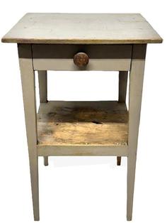 L409 Late 19th century Pennsylvania tapered leg side table with drawer and shelf below, bearing old gray painted surface.  The wood is pine with square head nail construction � with the legs and apron being fully mortised and pegged and the drawer being dovetailed. Circa 1860s. Measurements: 19 1/8� wide x 18 &frac12;� deep x 30 &frac34;� tall. 13� clearance from bottom shelf to floor. 11 &frac14;� clearance between lower shelf and apron.  