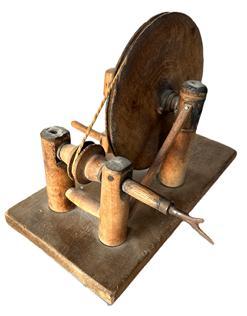 L24 Late 18th century to early 19th century handmade wooden Apple Peeler / Parer. Solid wood with small cut nail construction. The cord-powered mechanism is essentially a wheel and pulley system that uses a large wheel to drive a smaller wheel with an adjustable threaded belt tightener. A patent was granted in New York for a similar style wooden apple peeler / parer in December 1829. Approximate measurements: 12 &frac12;� long x 6 &frac14;� wide x 9� tall.  
