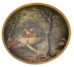 L119 19th century hand polychrome painted wooden bowl with a winter landscape scene of house by a stream in the snow � with a bundled-up person standing on a wooden bridge in the forefront. Unsigned. The bowl is in good condition with no cracks or breaks.  Slightly out of round. Measurements: 14� x 13 &frac12;� diameter x 3 &frac14;� tall. 
