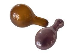 K1700B Group of two hand blown glass sock darners. One is amethyst with prominent bubbles in the glass and measures approximately 5 &frac14;� long x 2� wide x 1 &frac12;� thick. The other is heavy amber blown glass with prominent bubbles in the glass, rough cut pontil and measures approximately 5� long x 3� diameter on one end and 1� diameter on the opposite end.  