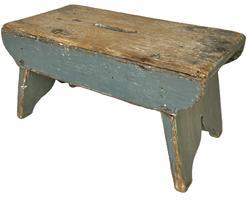 K1605 19th century Pennsylvania splayed leg Stool in its original pewter gray paint. Drop aprons with beaded edges and shaped ends adorn both sides of the stool.  Decorative cut out feet and an oval hole in center of top for carrying purposes. Small wire nail construction. The wood is pine. Measurements: 18� long x 9 &frac14;� wide x 9 &frac14;� tall.   