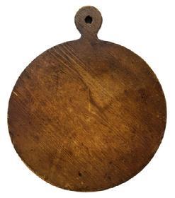 M175 19th century Pennsylvania round wooden cutting board with lollipop shaped top bearing remnants of blue painted edges and natural patina surface on each side with evidence of chop / slice marks from years of use. The shaped top has a hole for hanging purposes. The wood is pine. Measurements: 19 5/8� long x 16 5/8� wide x &frac34;� thick. 