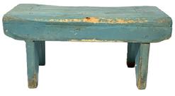 M143 19th century Pennsylvania Stool in its old blue paint over the original red paint with the initials �H F� on the bottom of one apron. Drop aprons with shaped ends adorn both sides of the stool.  Legs are single mortised through the top and end in boot jack cut-out feet. The wood appears to be pine with square head and wire nail construction. Measurements: 17 &frac34;� long x 7 &frac34;� wide x 8� tall.  