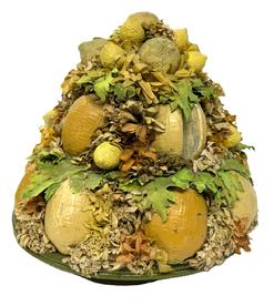 M200 Original Folk Art Fruit Arrangement attributed to Doris Stauble (1917 - 2007) of Wiscasset, ME. Doris was a documented folk artist who created arrangements from 19th century Victorian millinery supplies.  This arrangement is in good condition and consists of an abundance of lemons and artificial foliage arranged in a shallow woven basket with footed base and green painted edges. Circa 1950. Approximate measurements: ~9� diameter x 9� tall at center. Rests on footed base of basket that is 5 1/5� diameter.  