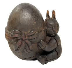 M216 19th century hand carved wood Rabbit hugging an Oversized Egg with large bow Papier Mache mold retaining its original surface.  Solid hand-carved wood construction with great details, and a large surface crack from age and drying of the wood. This type of mold was used as a pattern to make Papier Mache� Christmas, Easter and Halloween items. You can see fine knife cuts throughout, especially on the ears, where the Papier Mache was cut away when dry. A cute decorative piece of history. Approximate measurements of the Putti are: ~11 &frac14;� wide x ~8� deep x ~12� tall.  