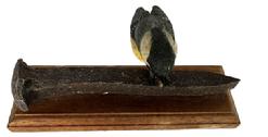 M293 Exceptionally detailed hand carved and painted Folk Art carving of a Chickadee with a sunflower seed perched on an �Iron� Railroad Spike (all wood) signed and dated �Ciesielski 2001� on the bottom. The carver, Vincent A. Ciesielski (b. 1938 � d. 2021) of Harrisburg, West Hanover Township, Pennsylvania, is known for his realistic, superb details in each lifelike carving. Overall measurements:  7 &frac34;� x 2 3/8� x ~3 &frac14;� tall.