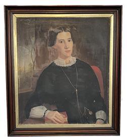 K1522 19th century American School Oil on Canvas Portrait of a Woman. Some of the exceptional details within this portrait include ultra realistic facial features, a lace collar with beautiful broach, a long gold chain with watch, decorative sleeve �bracelets� with blue / red colored beads/jewels, and a book beneath the finely detailed fingers of her right hand. A curved trellis and the tall steeple of a church are visible in the through the window painted in the background. Very small hole in canvas by her left forearm. Framed measurements:  30 &frac12;� wide x 2� thick x 34 &frac12;� tall.  Canvas measures 25 &frac14;� wide x 29 &frac14;� tall
