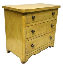 **SOLD** M220 Diminutive late-19th Century Pennsylvania mustard painted child�s chest of drawers featuring decorative cut out drop apron on front, rounded front corners on top as well as chest, cut out feet and three drawers with brass knobs. The woods are pine and walnut with small wire nail construction. Circa 1890s. Measurements: 14 &frac34;� wide x 8 &frac12;� deep x 13 &frac34;� tall. 