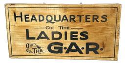 RM1620 Single sided wooden sign advertising �Headquarters of the Ladies of the G.A.R.� in black lettering on a discolored white painted background. Original eye hooks remain in the top for hanging purposes. Unsigned. Measurements: 21 5/8� wide x 11� tall x 7/8� thick. (NOTE: The Ladies of the G.A.R. refers to the �Ladies Grand Army Republic� � a Women�s Auxiliary Organization founded in 1866 for the mothers, daughters, wives and sisters of Union Veterans of the Civil War that is dedicated to preserving the history of the Union and advocating for veteran�s rights and benefits.) 