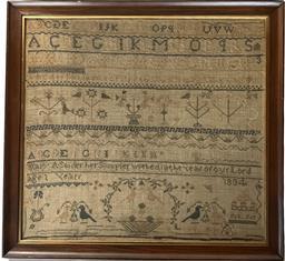 **SOLD** K1796 19th century American Schoolgirl Needlework Sampler Signed �Mary A. Snider her Sampler worked in the year of our Lord 1834�  �Age 1 (?) Years�.  Sampler is stitched with what appears to be cotton threads over linen material and boasts blues, browns, tans, green, pink and ecru colors in a row-by-row format featuring repeating alphabets, numbers, and geometrical patterns. Various versions of flowers, birds and trees in baskets / urns and a multi-storied house adorn the field of the sampler. This Sampler has been professionally mounted and framed and bears the original framer�s label from �Buckingham�s Inc. � Washington D.C.� intact on back.  Framed measurements: 21� wide x &frac34;� thick x 19 &frac12;� tall. 