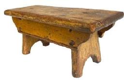 **SOLD** K1610 19th century Pennsylvania original mustard painted footstool boasting half-moon cut out feet and double drop aprons bearing shaped ends and a beaded edge. Top bears rounded edges on all sides. The wood is pine � with square head nail and early screw construction. Very sturdy. Circa 1850s. Measurements: 14� long x 5 &frac34;� wide x 6 &frac14;� tall.    