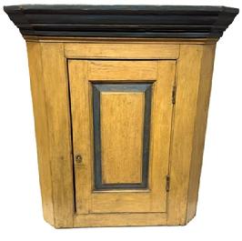 **SOLD** M195 Early 19th century Pennsylvania hanging Corner Cupboard in the original mustard and blue paint. This Cupboard has a single raised panel door which is mortised and pegged that opens to reveal a clean interior bearing a brown painted surface. Nice, applied molding along the top. Combination of pegged and square head nail construction. Circa 1820s. Measurements: 34 &frac12;� tall and takes a 22� corner. 