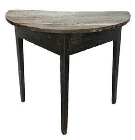 L211 18th century Maryland demilune table in old black paint. Table is circa 1780-1790s and features a semi-circular two-board top secured to the apron with large rosehead nails and �T� nails over a plain, triangular-shaped apron with beaded edge along the bottom that rests on three gracefully tapered legs. Measurements: 31 &frac14;� wide x 17 &frac34;� deep x 28 &frac12;� tall. 