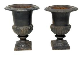 M182 Two small, heavy cast iron garden flower urns bearing their old black painted surfaces. These are very similar; however, they are not an exactly matched pair. Measurements: both are 7� top diameter and rest on 3 &frac34;� square bases; with one being 9� tall and the other being 8 &frac12;� tall.  