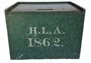 L507 19th century Pennsylvania slide lid Box in its original dry-green painted surface with the initials �H. L. A.� and the date �1862� painted in white on the front. A carved finger notch in the front edge of the lid allows easy opening of the smoothly sliding lid � which opens to reveal a clean, natural patina interior. The wood is pine with square head nail construction. Measurements: 16� wide x 11 &frac12;� deep x 11 &frac34;� tall. 