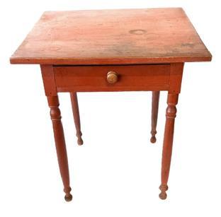 L218 Early 19th century Lancaster County, Pennsylvania turned leg side table with one dovetailed drawer. Original red painted surface with a pegged on top and gracefully turned legs resting on turned ball feet. The drawer is dovetailed front and back. Legs and apron are mortised. The wood is walnut. Measurements: 25 &frac34;� wide x 23 &frac12;� deep x 29 &frac12;� tall.   