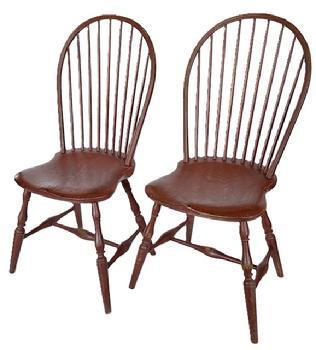 L12 Pair of early 19th century New England nine spindle bow back Windsor Chairs featuring beautiful saddle seats, bamboo turned spindles and legs with a center stretcher fastened to side runners with bold turnings in old red over original black paint. Circa 1800�1820. From a collection in Pennsylvania. Measurements: 20 &frac12;� wide across front legs x 38 &frac12;� tall (back). Seats are 17� wide x 17� deep x 17 &frac14;� tall.  