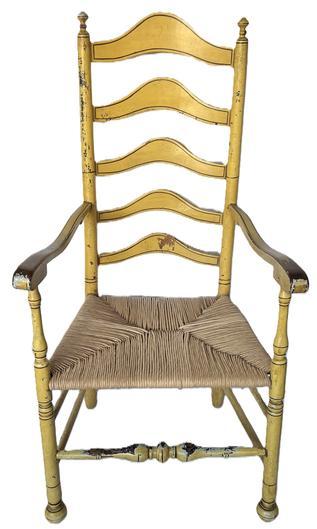 K1818 Fantastic Delaware Valley 18th Century, arched ladder back armchair retaining mustard yellow painted surface with pinstripe decoration and old woven rush-type seat. Chair retains nicely turned finials on top, as well as its original ball feet and boasts bold ball turnings on the front rung with nice wear. The five arched slats along the back are all mortised and pegged. Very sturdy. Retains good height. Circa 1750 - 1790. Measurements: 46 &frac12;� tall (back) x 24� wide (front arms) x 17 &frac12;� deep (seat). Seat height is 17�. 
